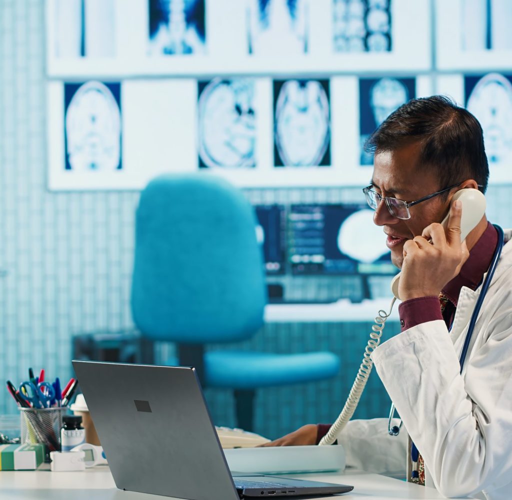 Young medical expert reviewing x ray test findings in medical office, providing a diagnosis for an ill patient. Physician studying hospital records and sharing his expertise. Camera A.